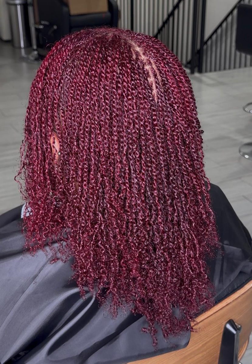 Client with burgundy colored locs worn loose